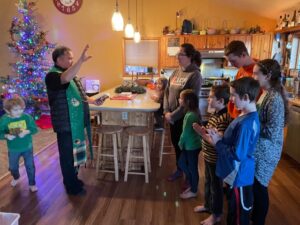 Second from left, Father Jaime Mencias, the priest of St. John the Baptist Catholic Church in Homer, blesses the Traugott family home.